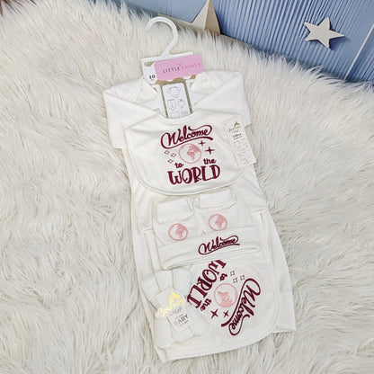 Baby outfit with 'Welcome to the World' text on a fluffy white surface